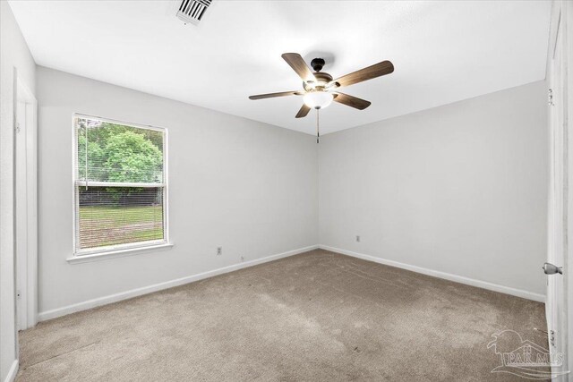 empty room with carpet floors, ceiling fan, and baseboards