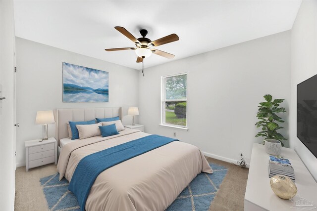 carpeted bedroom featuring baseboards and ceiling fan