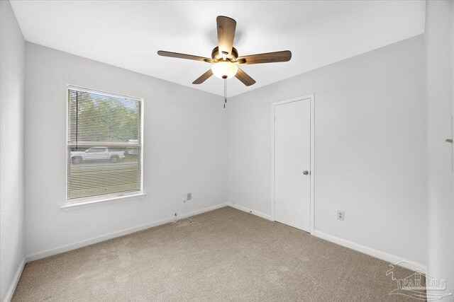 unfurnished room featuring carpet flooring, baseboards, and a ceiling fan