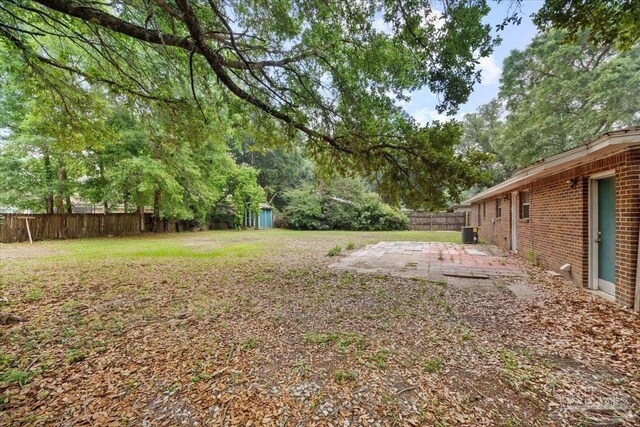 view of yard with a patio, a shed, an outdoor structure, and cooling unit