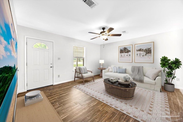 living room featuring wood finished floors, ceiling fan, and baseboards