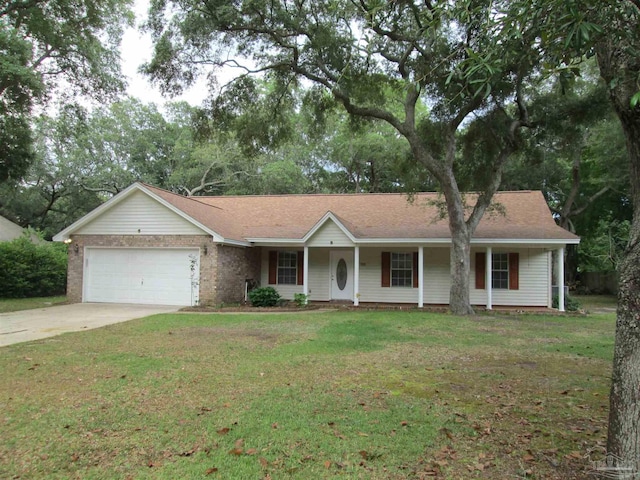ranch-style home with a garage, concrete driveway, a front yard, and covered porch