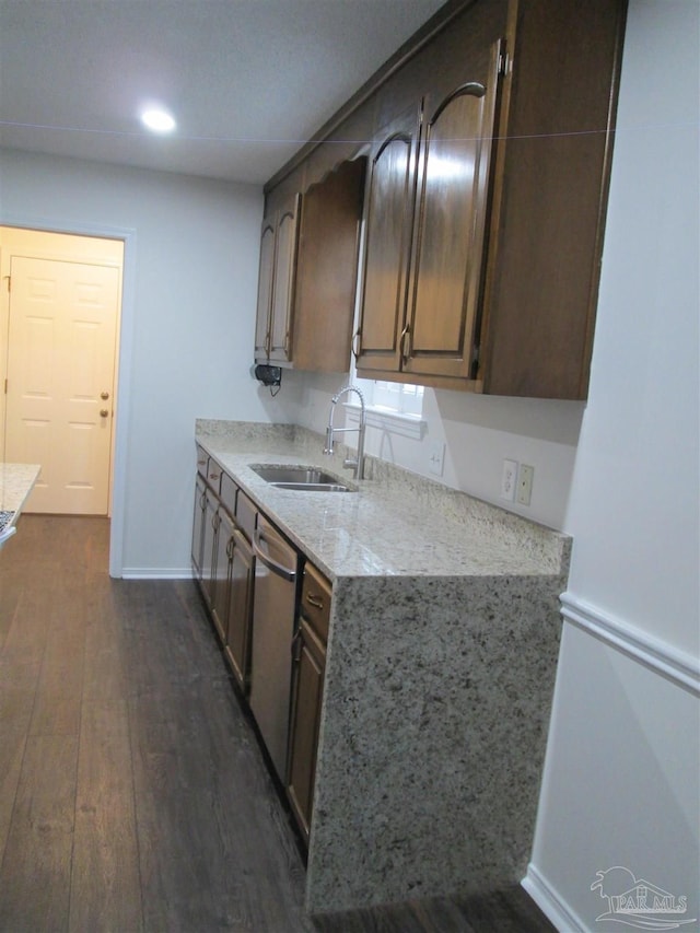 kitchen with a sink, dishwasher, dark wood-style flooring, baseboards, and recessed lighting