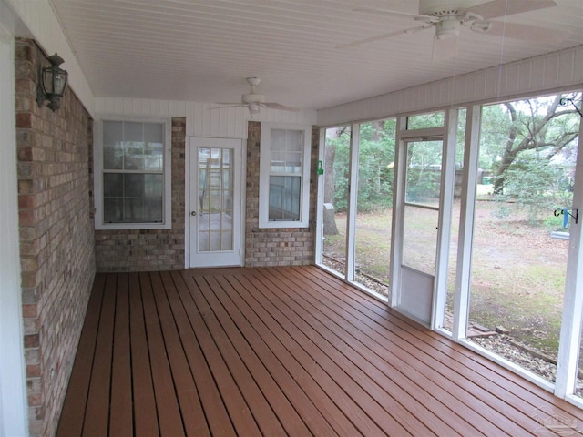 unfurnished sunroom featuring a ceiling fan