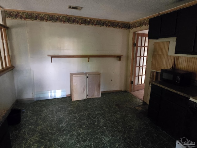35 N Cypress St, Mcdavid, FL 32568 - empty room with a textured ceiling and tile patterned floors