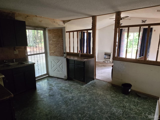 35 N Cypress St, Mcdavid, FL 32568 - kitchen featuring healthy amount of natural light, vaulted ceiling, heating unit, ceiling fan, and a textured ceiling