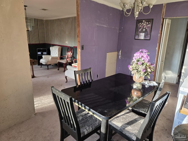 35 N Cypress St, Mcdavid, FL 32568 - carpeted dining room featuring a chandelier