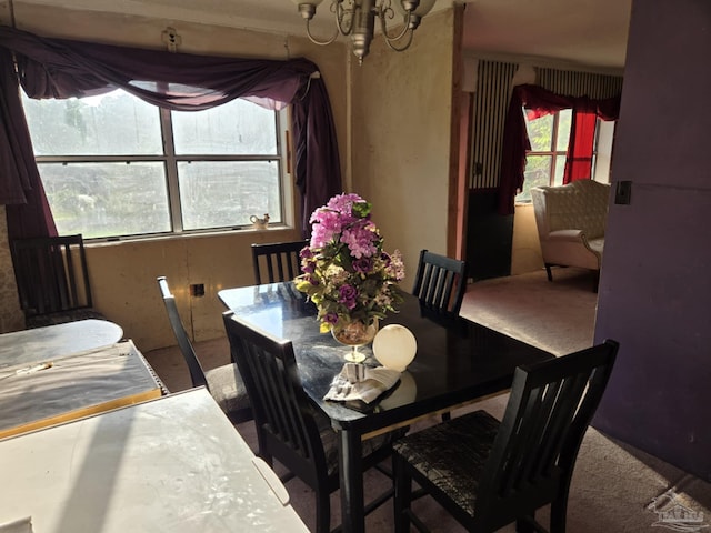 35 N Cypress St, Mcdavid, FL 32568 - carpeted dining room featuring a chandelier