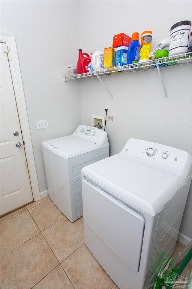 laundry room featuring light tile patterned floors and washing machine and clothes dryer