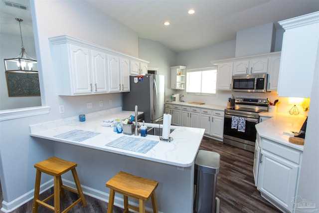 kitchen featuring appliances with stainless steel finishes, a breakfast bar, and white cabinets