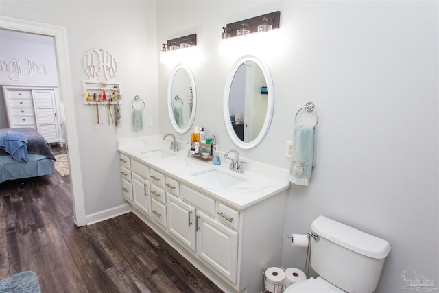 bathroom featuring vanity, toilet, and hardwood / wood-style floors