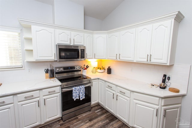 kitchen with white cabinets, stainless steel appliances, and dark hardwood / wood-style flooring