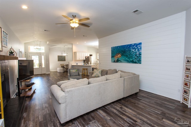 living room featuring lofted ceiling, ceiling fan, and dark hardwood / wood-style flooring