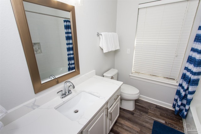 full bathroom with vanity, hardwood / wood-style floors, shower / bath combination with curtain, and toilet