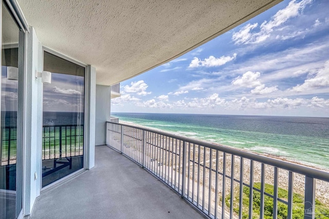 balcony with a view of the beach and a water view