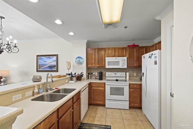 kitchen featuring crown molding, brown cabinetry, a sink, and white appliances