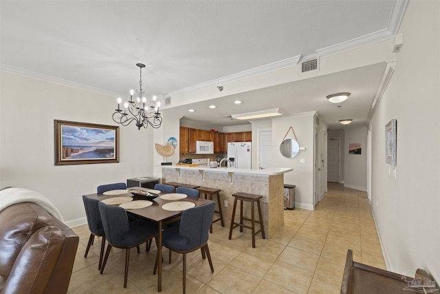 dining space with light tile patterned flooring, baseboards, visible vents, crown molding, and a notable chandelier