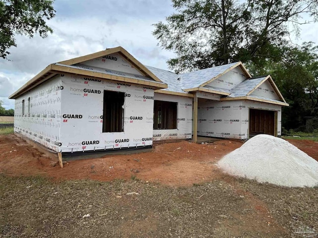 unfinished property featuring an attached garage