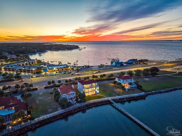 aerial view at dusk with a water view