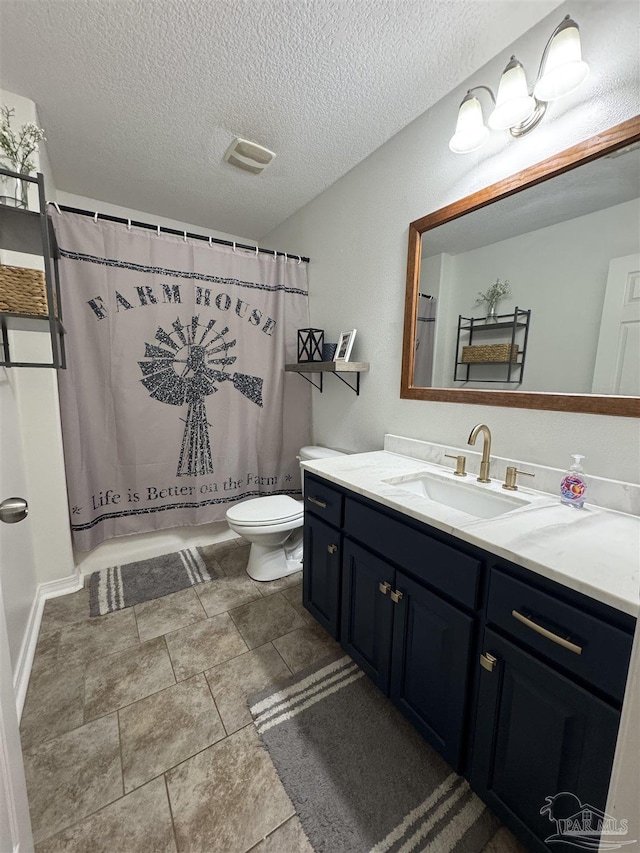 bathroom featuring toilet, vanity, a shower with shower curtain, and a textured ceiling