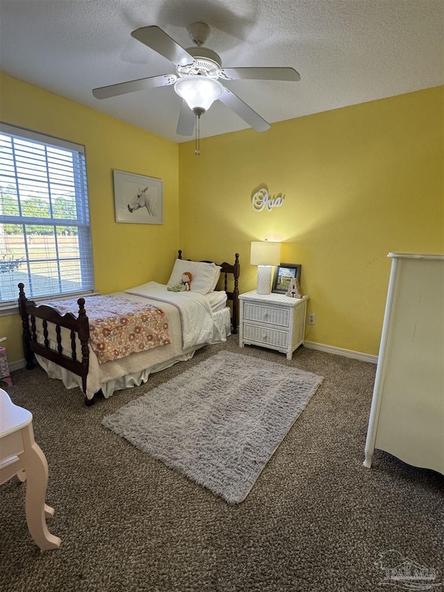 bedroom featuring carpet, ceiling fan, baseboards, and a textured ceiling