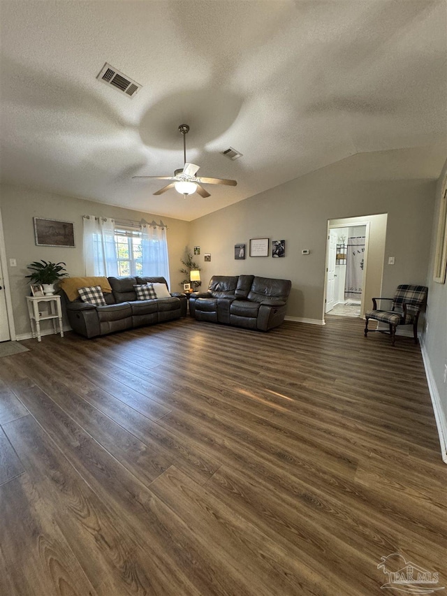 living area with a textured ceiling, visible vents, and ceiling fan