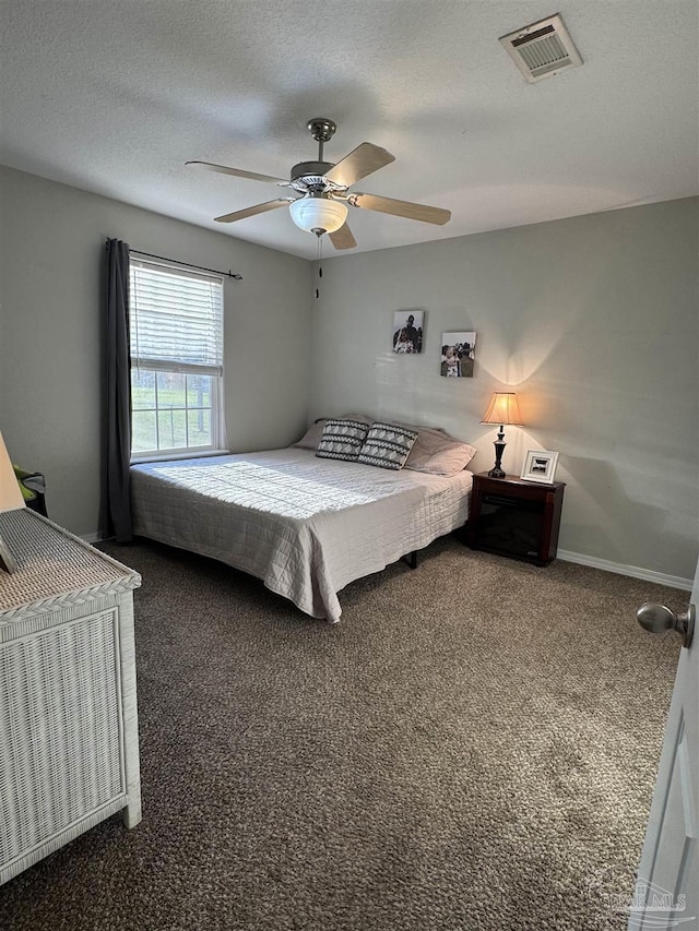 carpeted bedroom featuring a ceiling fan, visible vents, and baseboards