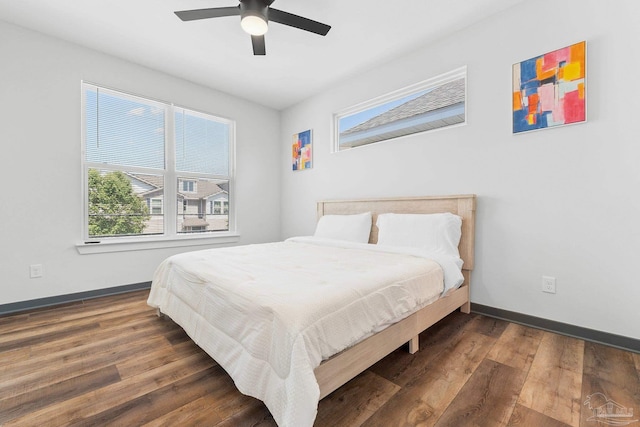 bedroom with dark hardwood / wood-style floors and ceiling fan