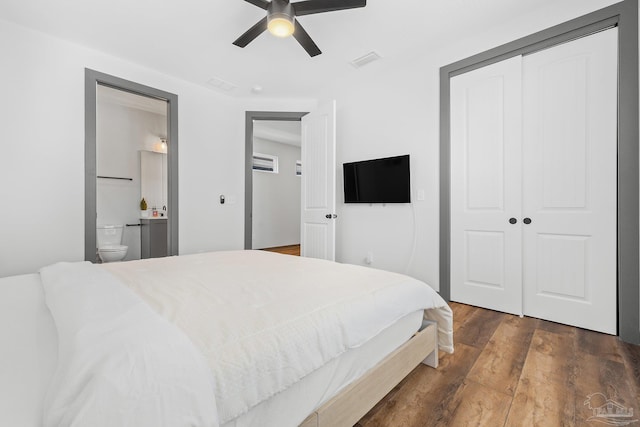 bedroom with ceiling fan, connected bathroom, dark hardwood / wood-style floors, and a closet