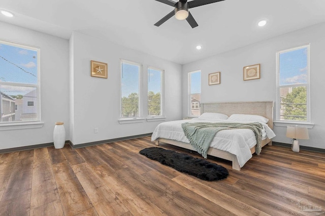 bedroom with ceiling fan and dark hardwood / wood-style flooring