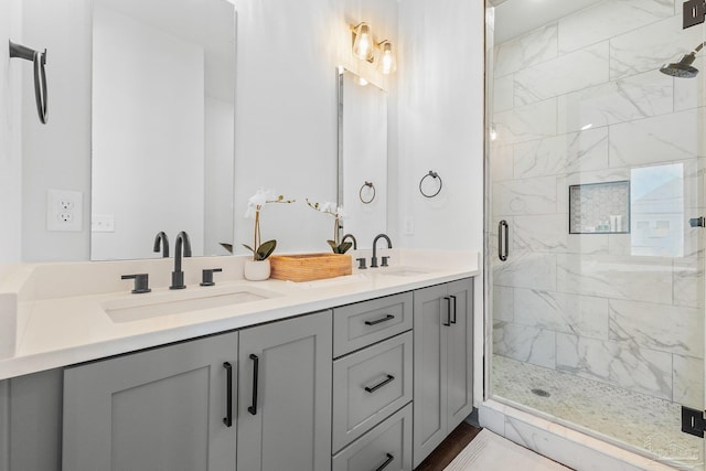 bathroom with vanity and a shower with shower door