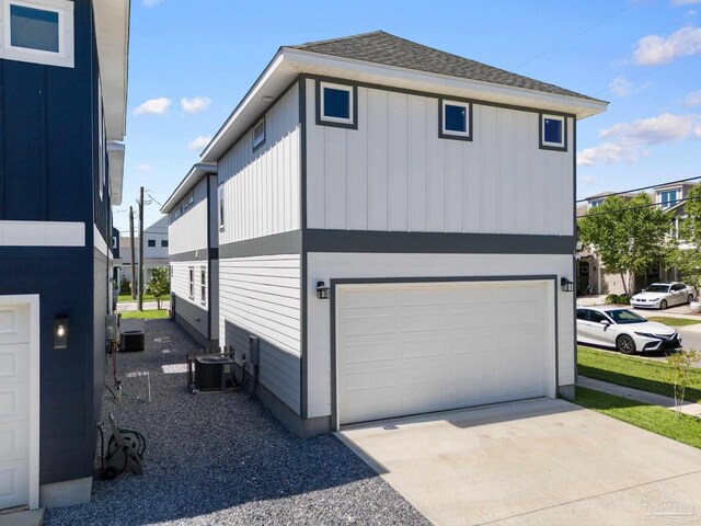 view of property exterior featuring cooling unit and a garage