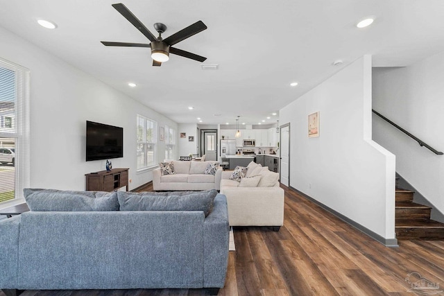 living room featuring dark hardwood / wood-style flooring and ceiling fan