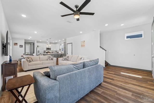 living room featuring hardwood / wood-style floors and ceiling fan