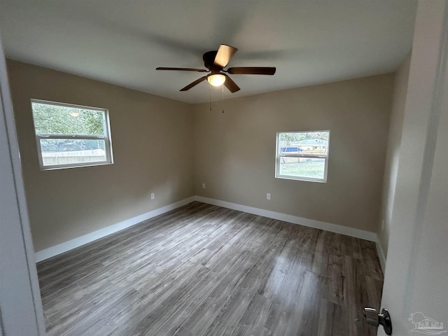 unfurnished room with dark wood-type flooring and ceiling fan