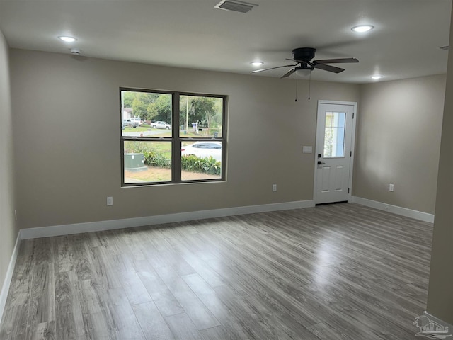 spare room featuring ceiling fan and light hardwood / wood-style flooring