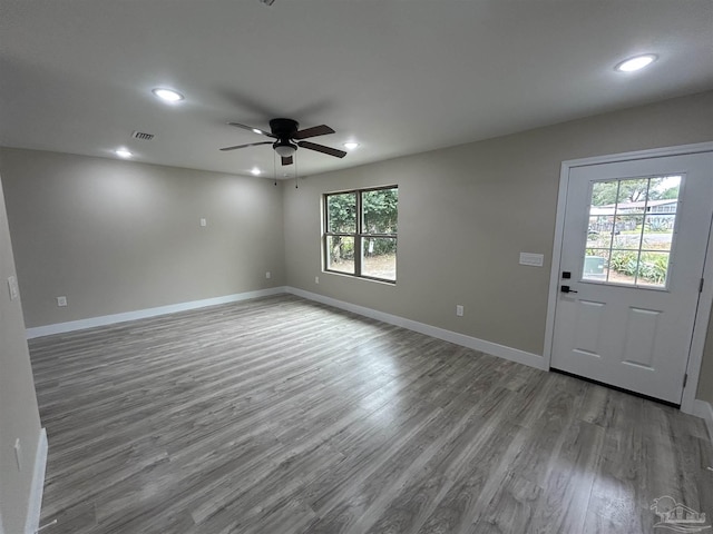 interior space with ceiling fan and wood-type flooring