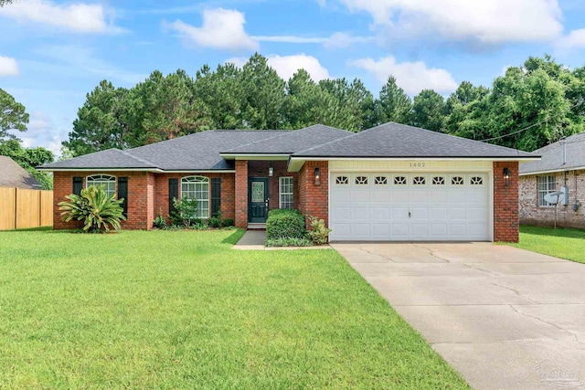 1602 Oakhill Rd, Gulf Breeze, FL 32563 - single story home featuring an attached garage, driveway, brick siding, and roof with shingles