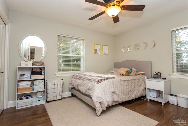 bedroom with baseboards, ceiling fan, and wood finished floors