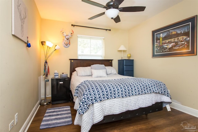bedroom featuring wood finished floors, baseboards, and ceiling fan