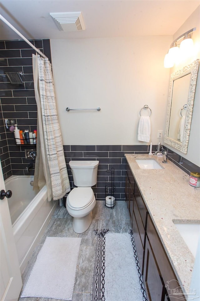 full bathroom featuring visible vents, shower / bathtub combination with curtain, toilet, a sink, and tile walls
