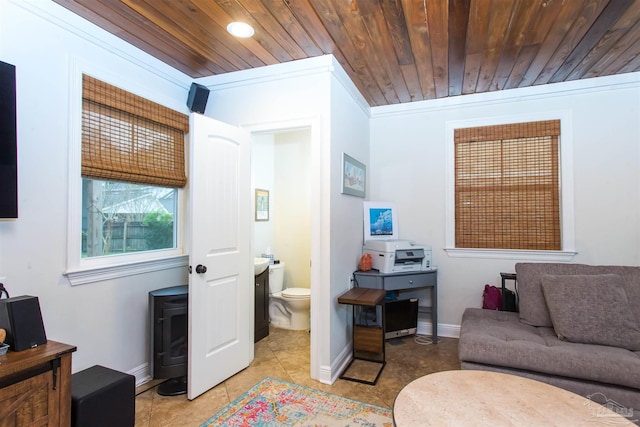 living room featuring light tile patterned floors, wood ceiling, baseboards, and ornamental molding