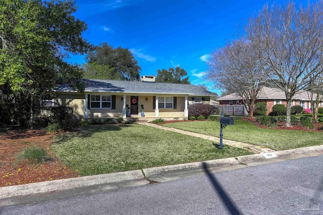 single story home with a front yard and fence