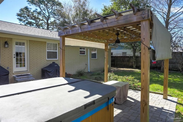 view of patio featuring entry steps, fence, a pergola, and a hot tub