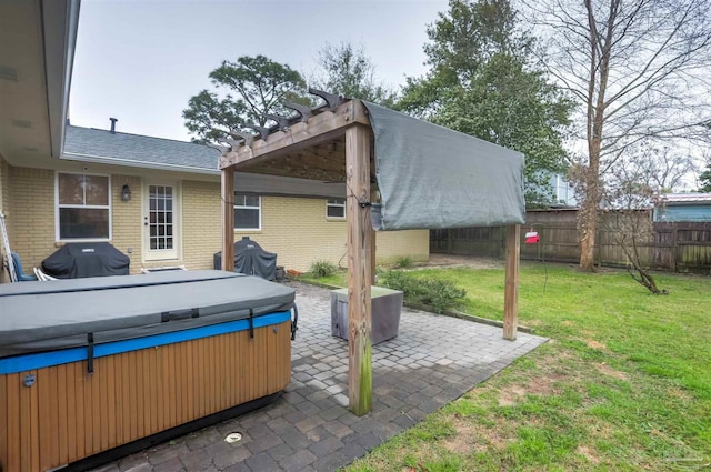 view of patio / terrace with fence, a grill, a pergola, and a hot tub