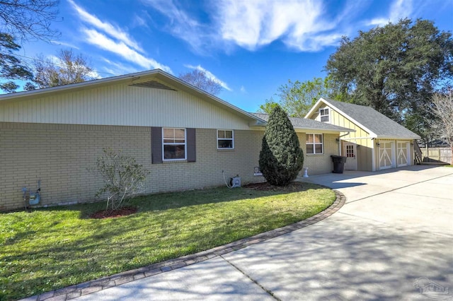 view of home's exterior featuring an attached garage, a lawn, brick siding, and driveway