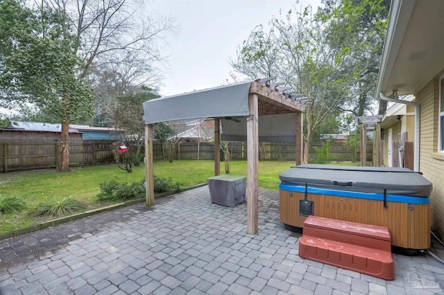 view of patio / terrace featuring a hot tub and a fenced backyard