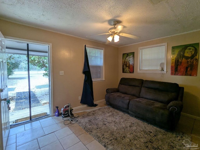 tiled living room with crown molding, a textured ceiling, and ceiling fan