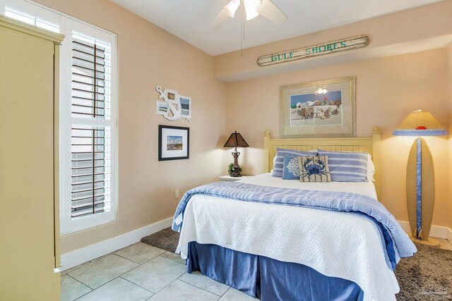 521 W Beach Blvd Unit 702, Gulf Shores, AL 36542 - tiled bedroom featuring ceiling fan and baseboards