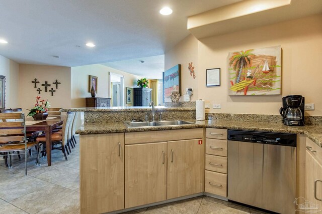 521 W Beach Blvd Unit 702, Gulf Shores, AL 36542 - kitchen with light tile patterned floors, a peninsula, light brown cabinetry, stainless steel dishwasher, and a sink
